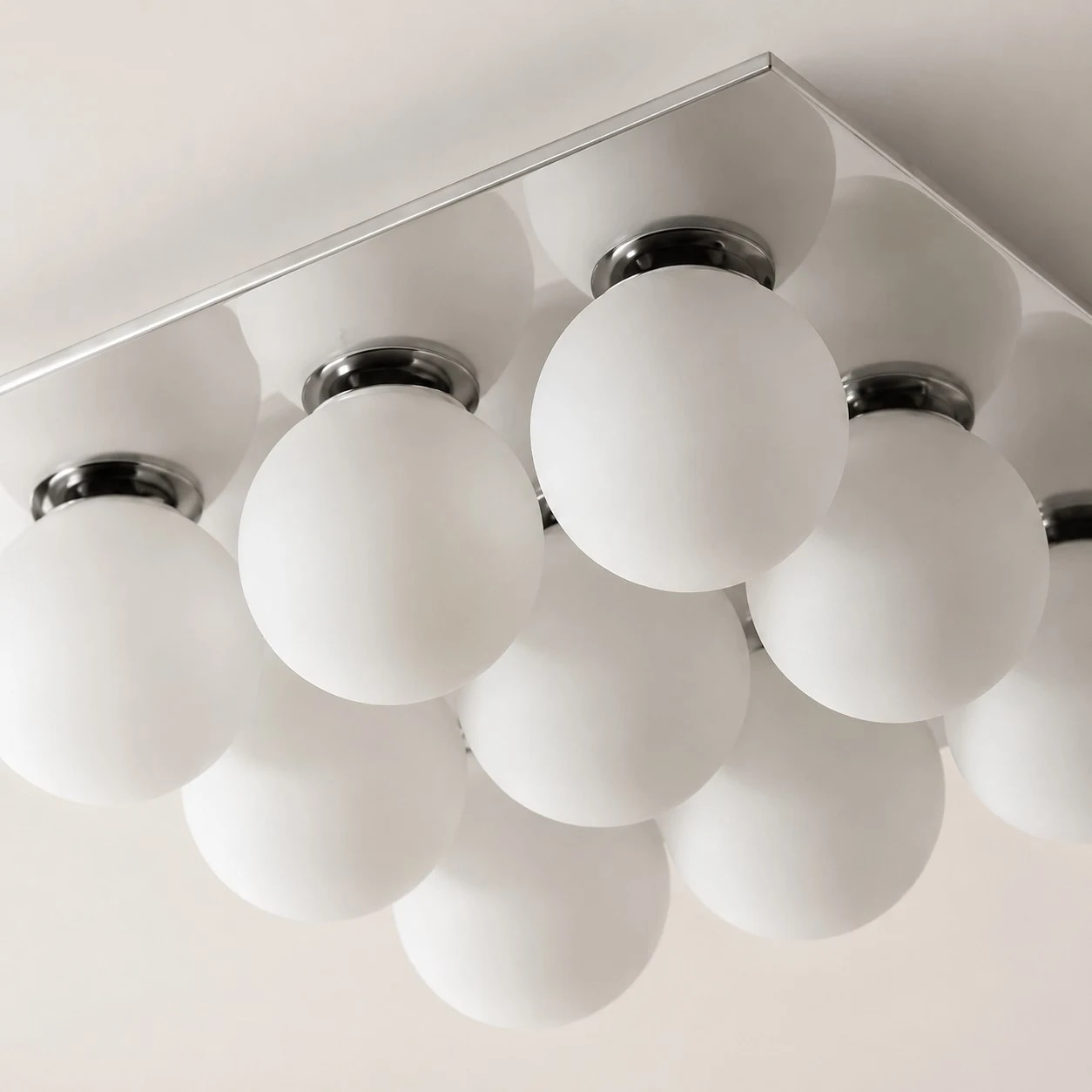 Frosted glass globes and chrome holders on the ceiling light