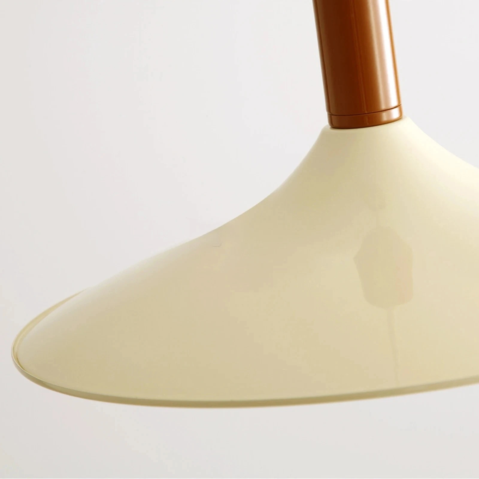Close view of the cream pendant shade surface and stem color finish