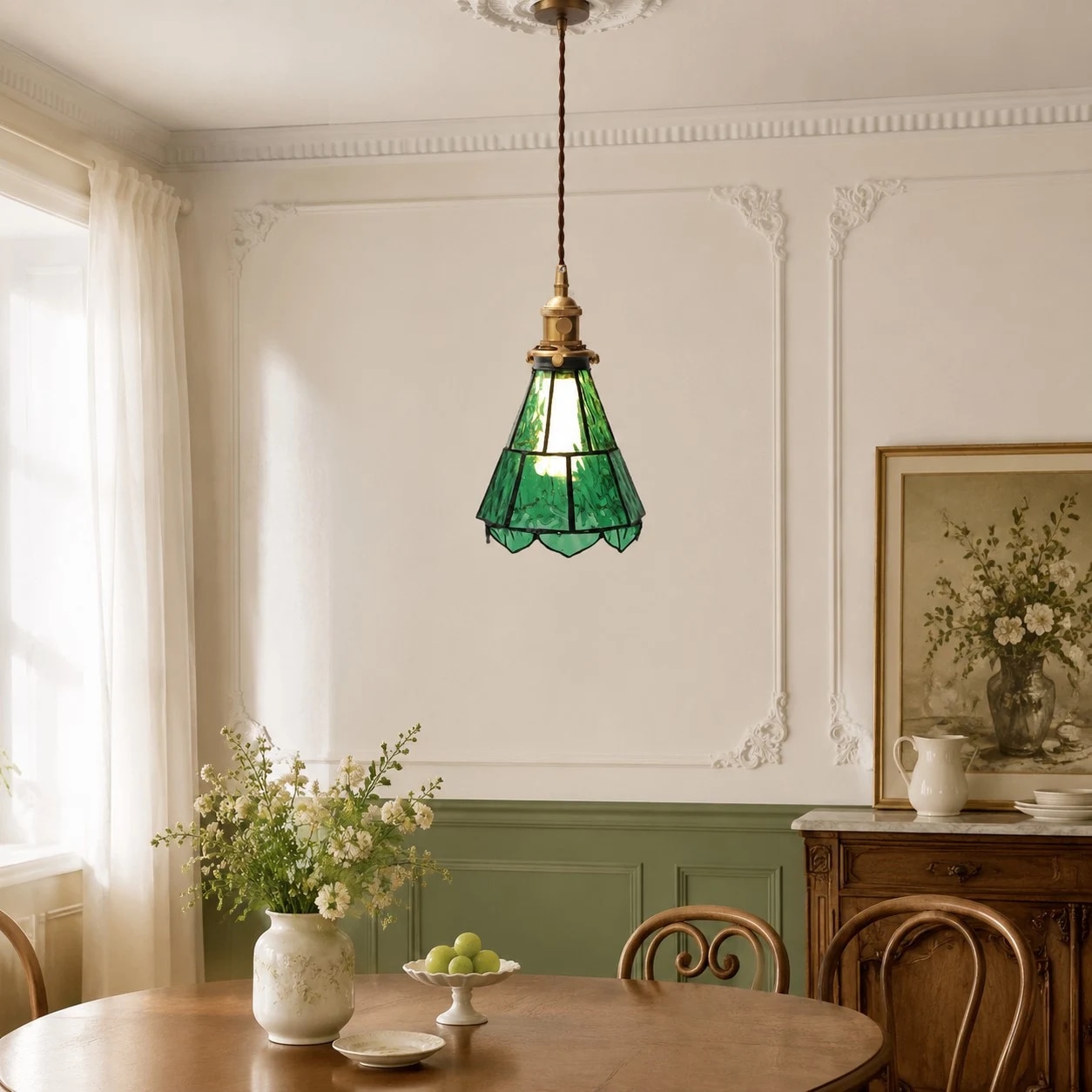 Green glass pendant in a dining nook